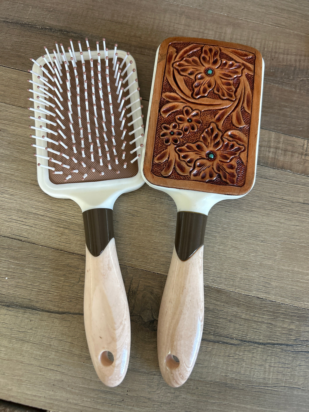 Hairbrush with tooled leather patch